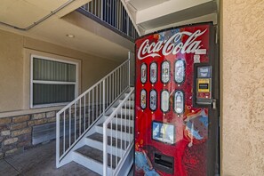 A Coca-Cola vending machine with a 'Thank You!' sign and a 'Dollar Bills' slot.