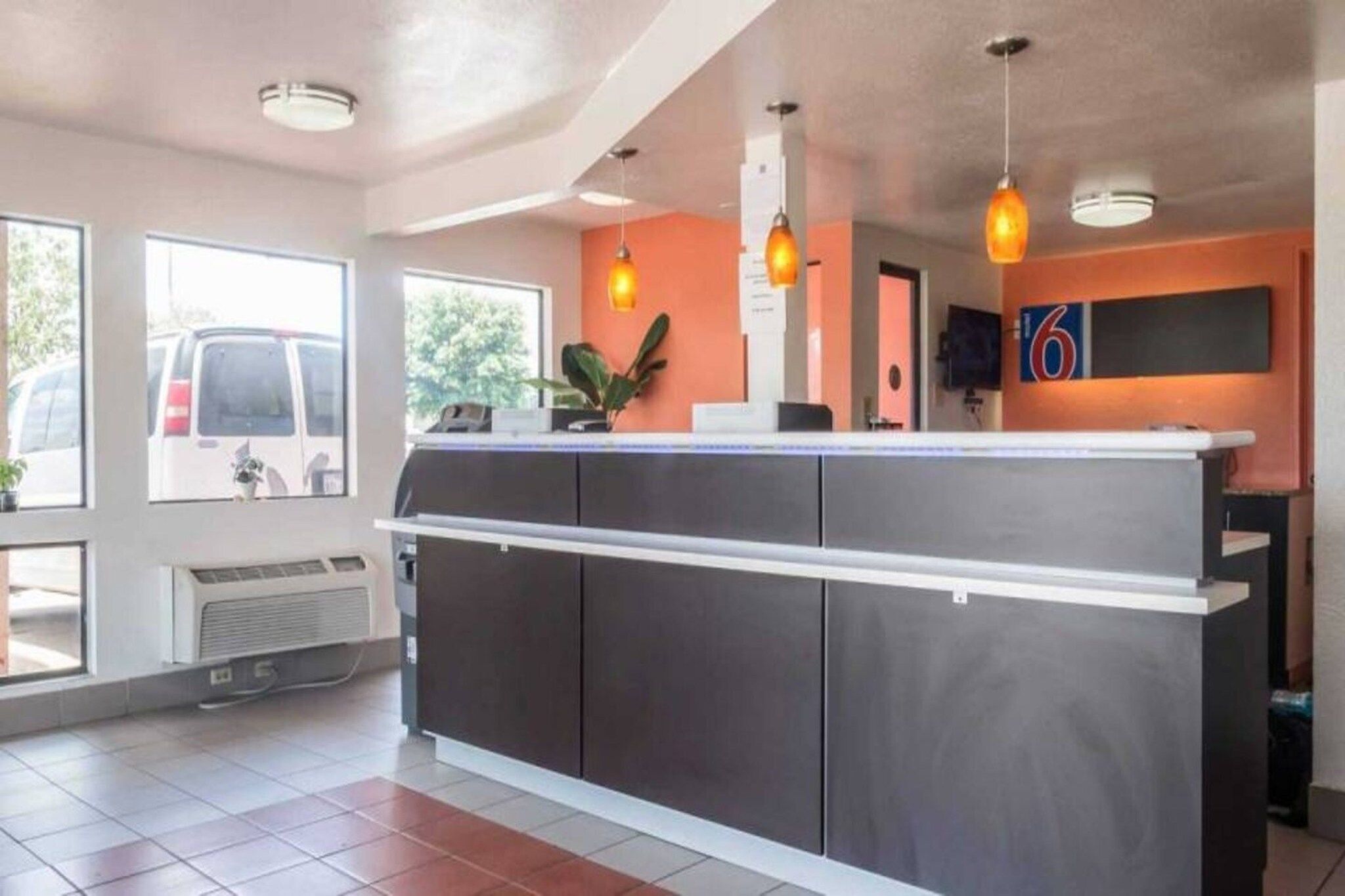 A reception area with a counter, a large window, and a door.
