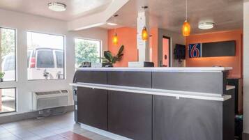 A reception area with a counter, a large window, and a door.