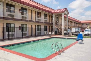 A hotel with a swimming pool, outdoor seating, and a covered area with stairs. - 1 Queen Bed|Mobility|Tub|Nsmk (MESQUITE)