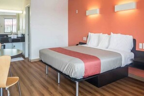 A hotel room with a bed, a chair, a desk, and a bathroom visible in the background. - 1 Queen Bed|Mobility|Tub|Nsmk (MESQUITE)