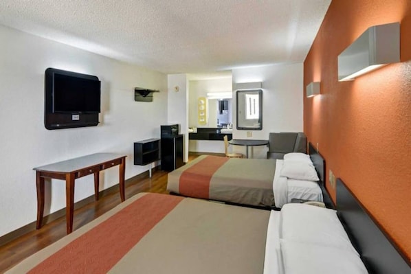 A hotel room with two beds, a desk, a television, and a kitchenette. - 2 Queen Beds | Nsmk, Micfridge (LINDALE)