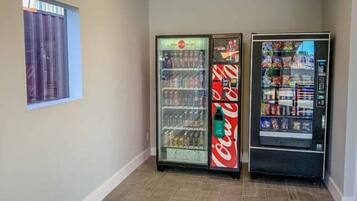 Un corridoio con due distributori automatici, uno con bevande e l'altro con snack.