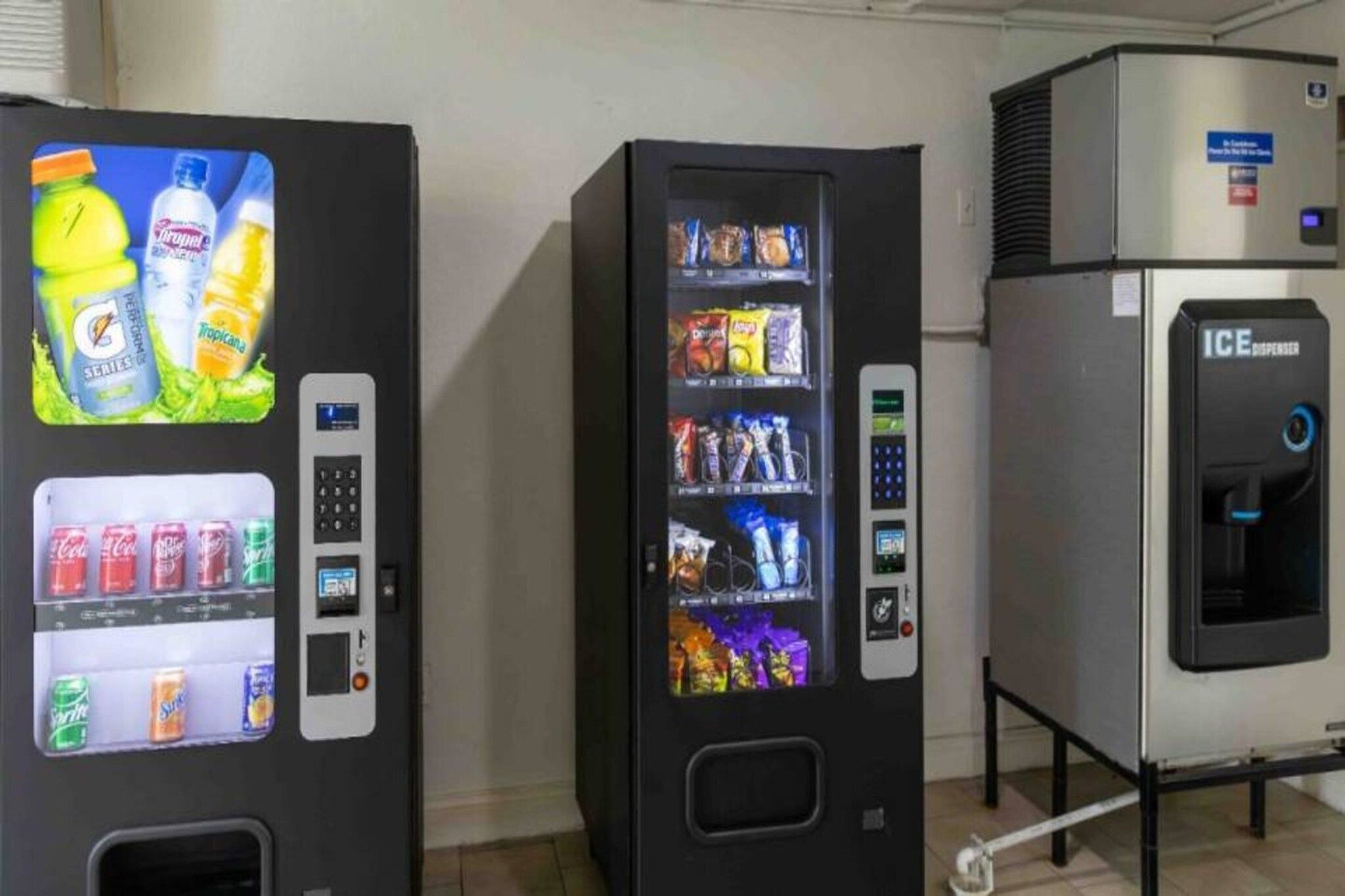 Two beverage vending machines with a selection of drinks and a water dispenser.