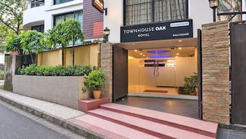 Una entrada de hotel moderna con un cartel que dice 'Townhouse Oak Hotel'.