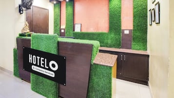 A reception desk with a sign reading 'HOTEL Company Serviced'.