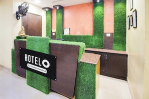 A reception desk with a sign reading 'HOTEL Company Serviced'. - Super OYO Hotel O Allipuram Near Railway (Visakhapatnam)