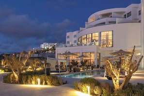 A modern hotel with a pool, outdoor seating, and a view of the surrounding area. - Idou Malabata Beach & Spa (Tangier)
