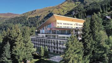 A hotel with a modern design, featuring a large glass facade and a flat roof.