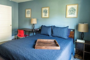 A bedroom with a bed, a desk, a chair, and framed botanical prints on the wall. - Cheerful & Homey ~ 7 Mins to Downtown ~ Queen Beds (Topeka)