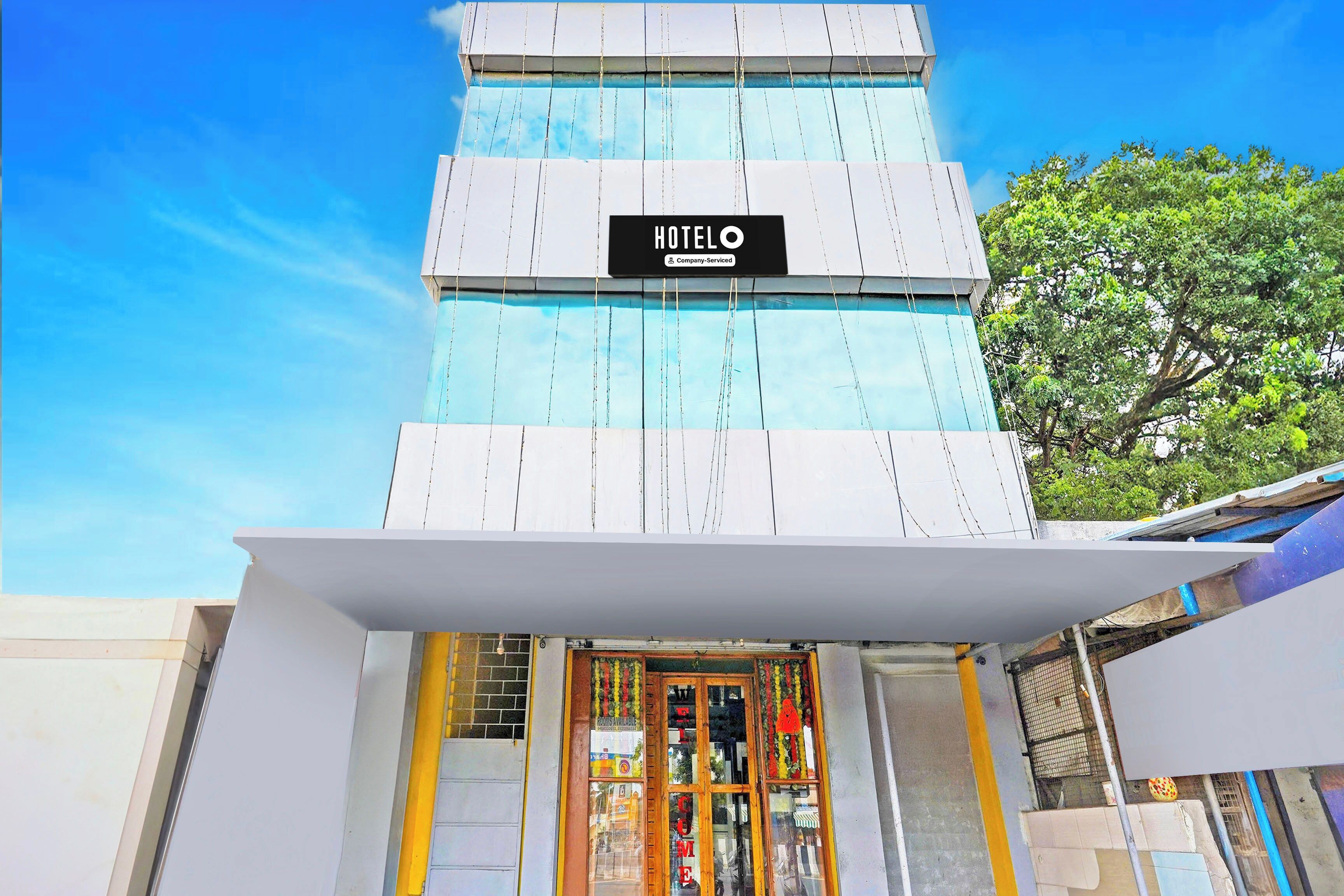 A hotel with a sign reading 'HOTELO' and a company-serviced logo.