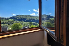 A window with a view of a green landscape and a hill. - Holiday apartment in Badenweiler with balcony (Badenweiler)