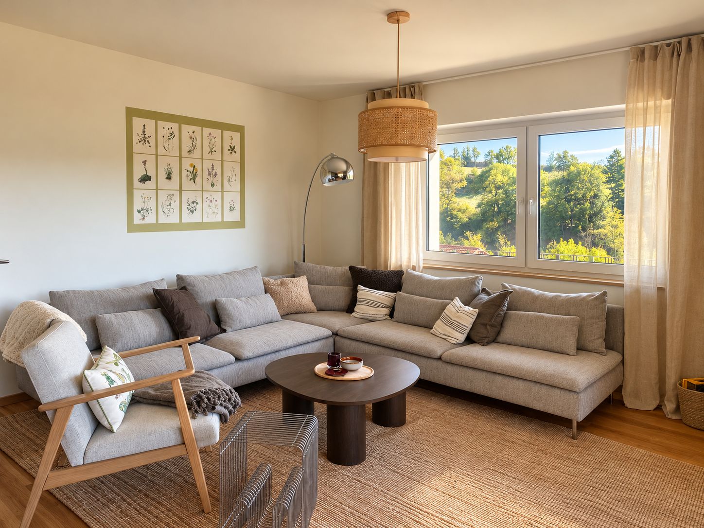 A modern living room with a sectional sofa, a round coffee table, and a hanging light fixture.