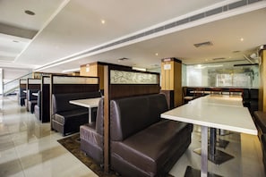 A modern restaurant interior with booth seating and high tables. - Townhouse Oak LB Nagar Ramoji (Hyderabad)