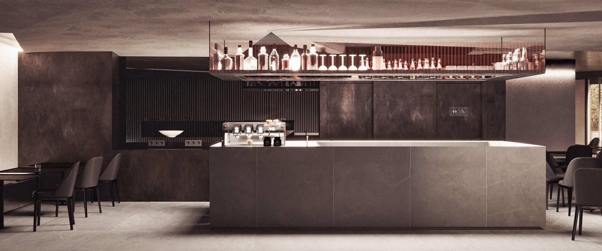 A modern bar area with a central island, seating, and a variety of bottles and glasses.