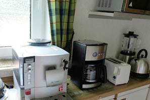 A kitchenette with a coffee maker, toaster, kettle, and a blender. - Holiday home in Borkum with swimming pool (Borkum)