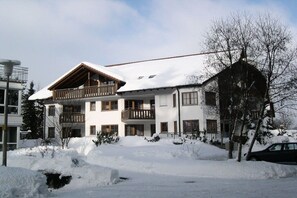A multi-story building with a snow-covered roof and balconies, surrounded by snow. - House at Gutach No. 10 (Titisee-Neustadt)
