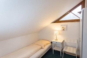A small, single-bed room with a desk and chair, a window, and a picture on the wall. - House at Gutach No. 10 (Titisee-Neustadt)