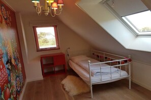 A child's bedroom with a bunk bed, a skylight, a red cabinet, and a wall mural. - Holiday home in Buren with swimming pool (Buren)