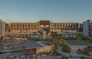 A hotel with multiple floors, outdoor seating areas, and a central courtyard. - Grand Hyatt Los Cabos Resort, Golf & Spa, All-inclusive (Cabo San Lucas)