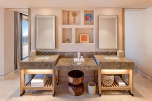 A modern bathroom with a double sink vanity, wooden storage shelves, and a decorative wall shelf. - Grand Hyatt Los Cabos Resort, Golf & Spa, All-inclusive (Cabo San Lucas)