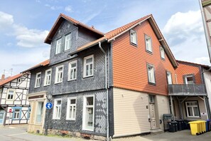 A two-story building with a gabled roof, multiple windows, and a visible door. - Holiday apartment with 2 bedrooms (Wernigerode)