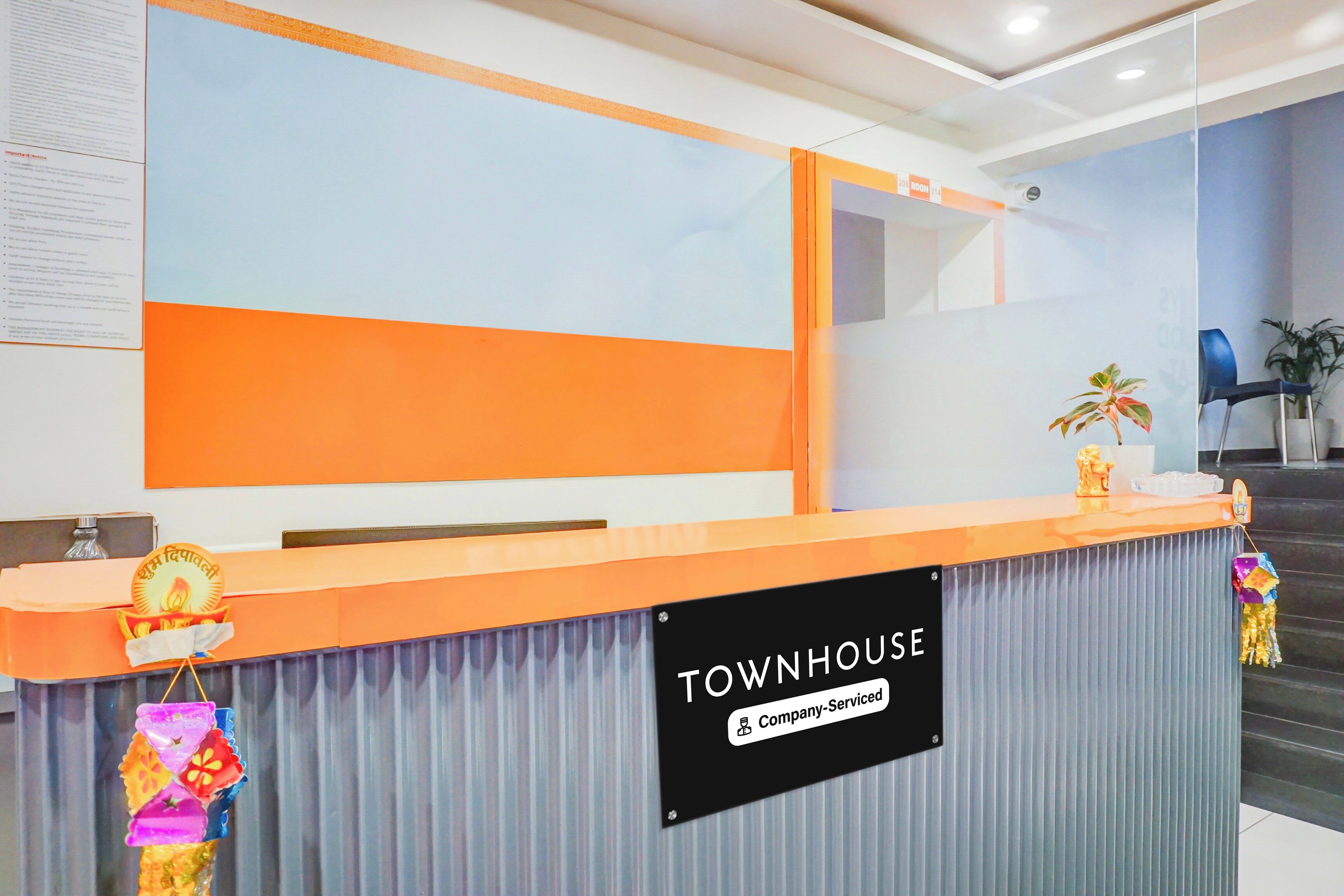 A reception desk with a sign reading 'TOWNHOUSE Company-Serviced'.