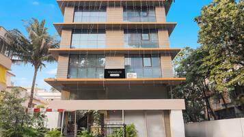 A multi-story building with a sign reading 'TOWNHOUSE Company-Serviced'.