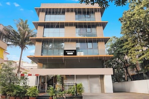 A multi-story building with a sign reading 'TOWNHOUSE Company-Serviced'. - Townhouse Hadapsar (Pune)
