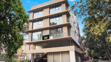 A multi-story building with a sign indicating it is a company serviced townhouse.