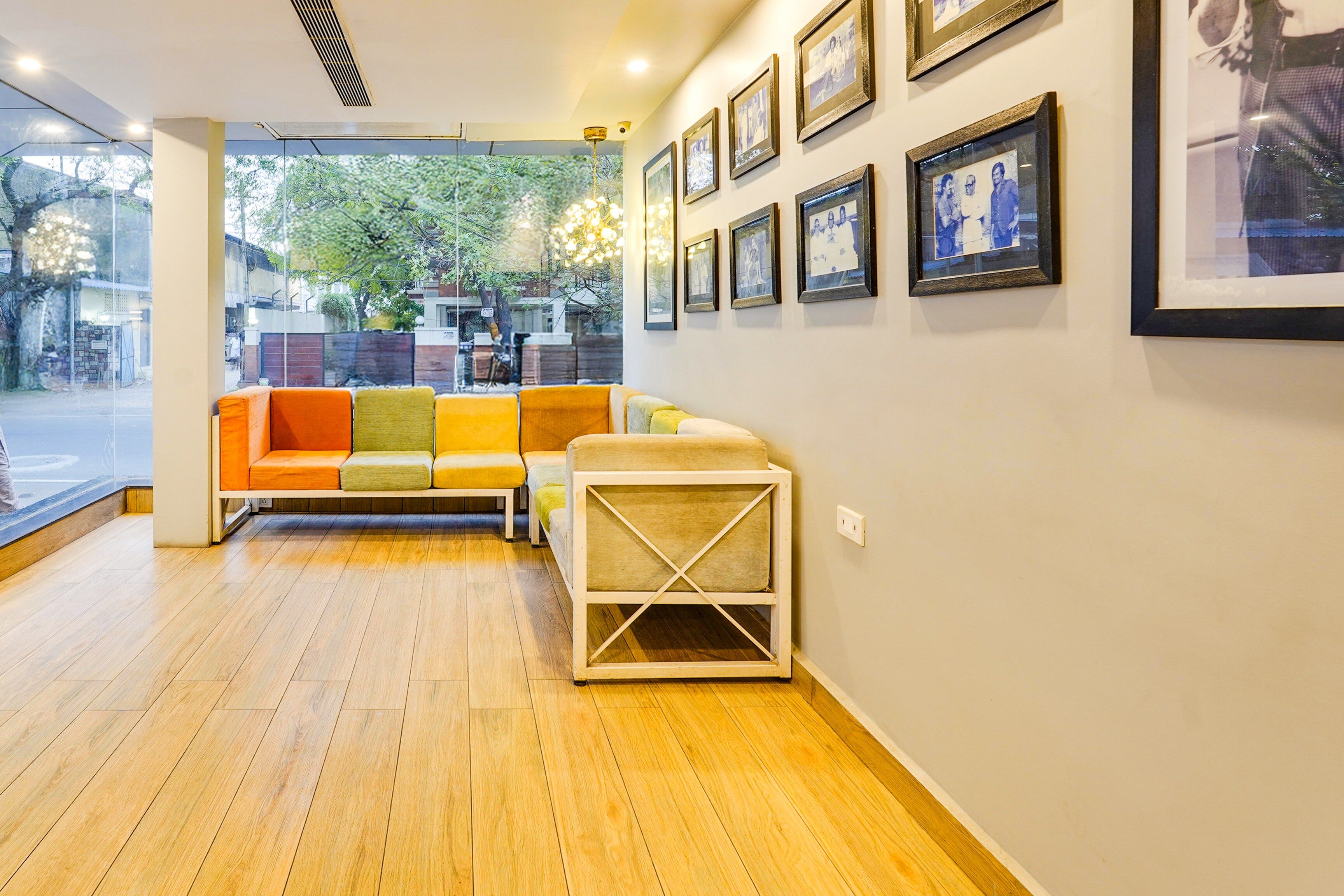 A modern interior with a wooden floor, a colorful sofa, and a small white table.