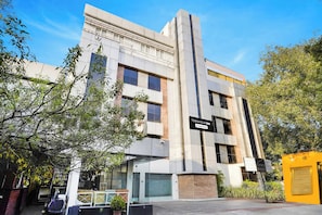 A modern building with a sign indicating 'Townhouse Oak' and a company-serviced symbol. - Townhouse Oak Kodambakkam (Chennai)