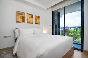 A modern bedroom with a large bed, a balcony with a view, and abstract art on the wall. - Skypark Celeste 6, One-bedroom 6108 1Bx Ground Floor (Choeng Thale)