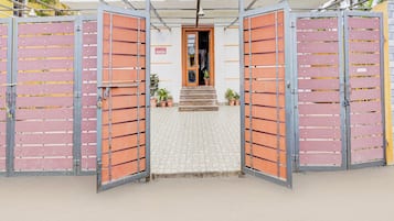 A hotel entrance with a metal gate and a sign indicating car parking.
