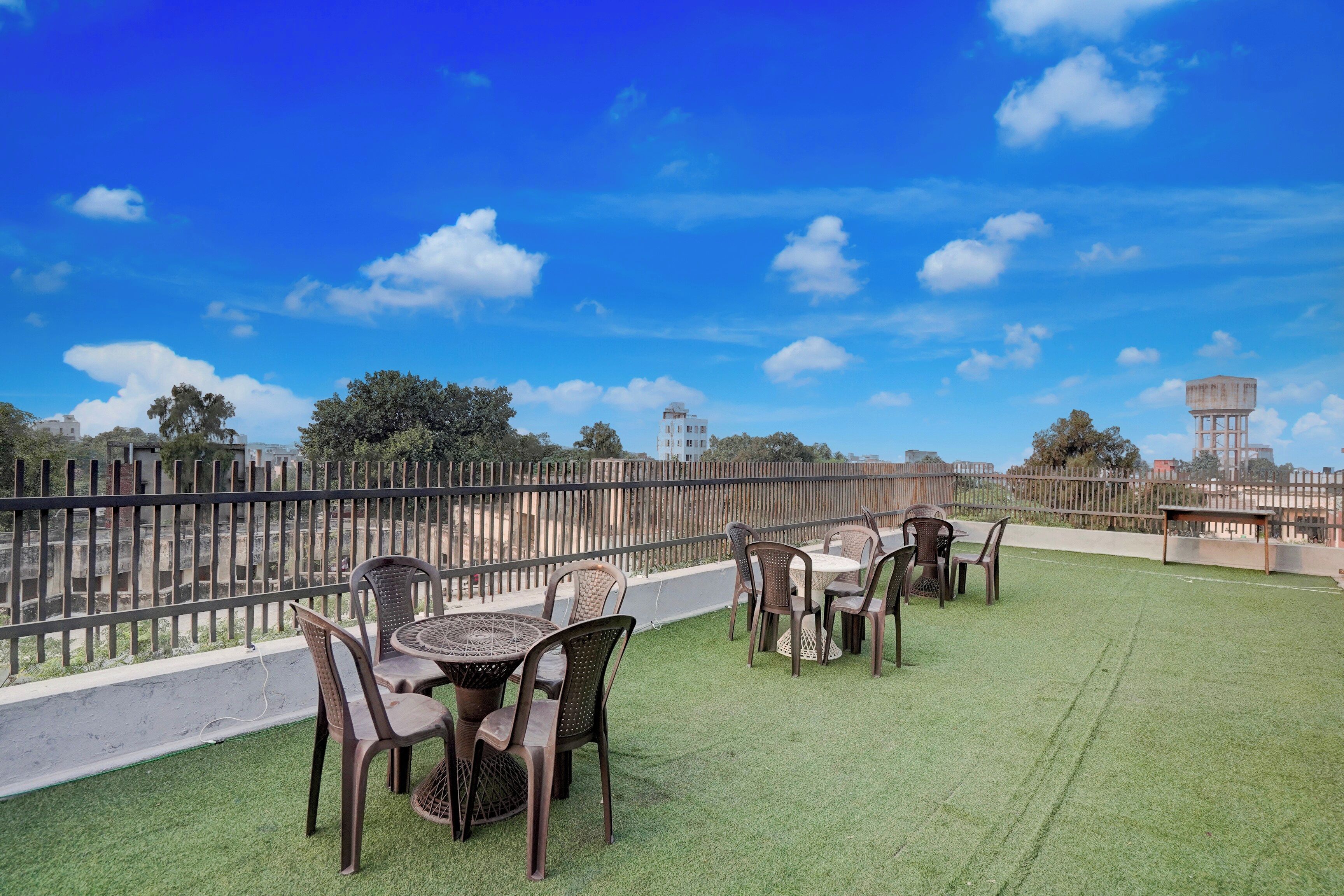 A rooftop terrace with outdoor seating and a view of the cityscape.