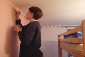 A person standing in a room with a bunk bed and a wall with star-shaped decorations. - Cabin in Drognitz with swimming pool (Drognitz)