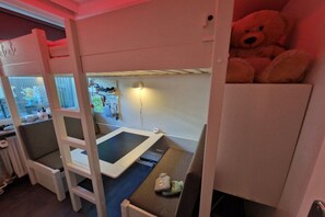 A bunk bed with a tablet on the lower bunk and a teddy bear on the upper bunk. - Holiday apartment with 2 bedrooms (Heiligenhafen)