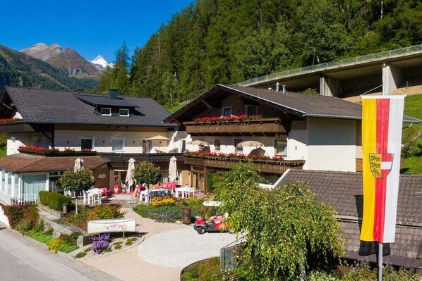 Ett hotell med en fantastisk bergsutsikt, en restaurang med uteservering och en flagga.