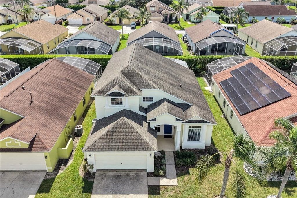 A residential area with multiple houses, each with a distinct roof style and a garage.