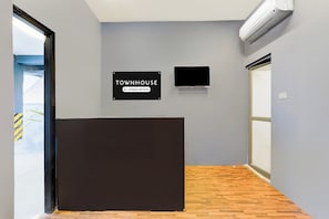 A reception area with a sign indicating it is a company-serviced townhouse. - Townhouse Nanganallur Near Chennai (Chennai)