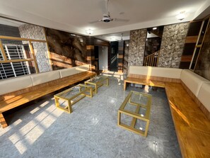A modern interior with a seating area, marble flooring, and a staircase. - HIDDEN GEM (Jamtha)