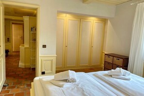 A hotel room with a bed, a wardrobe, and a small wooden cabinet. - Holiday apartment in Sylt with 1 bedroom (Sylt \/ Alt Westerland)