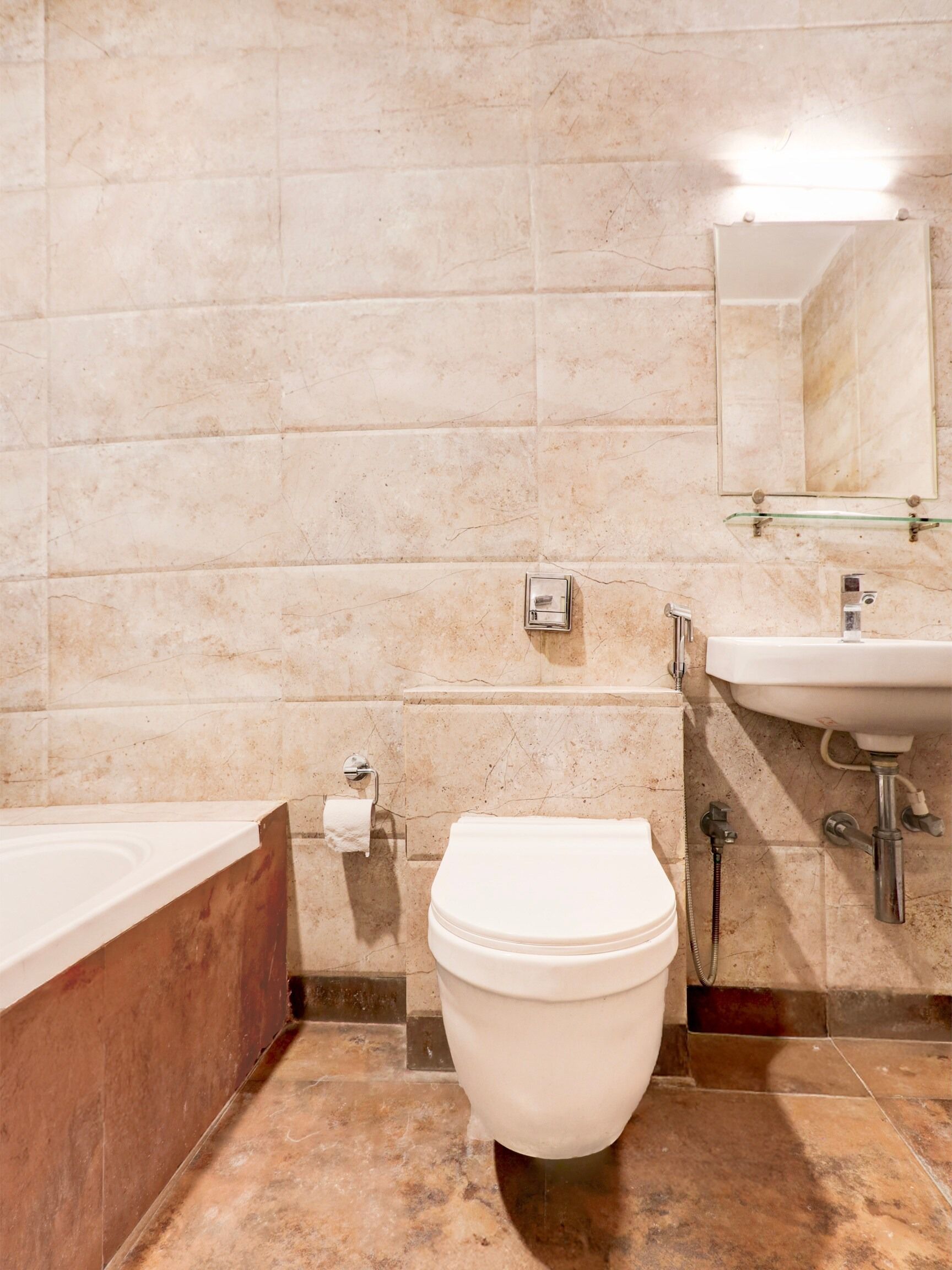 A bathroom with a toilet, sink, and bathtub.