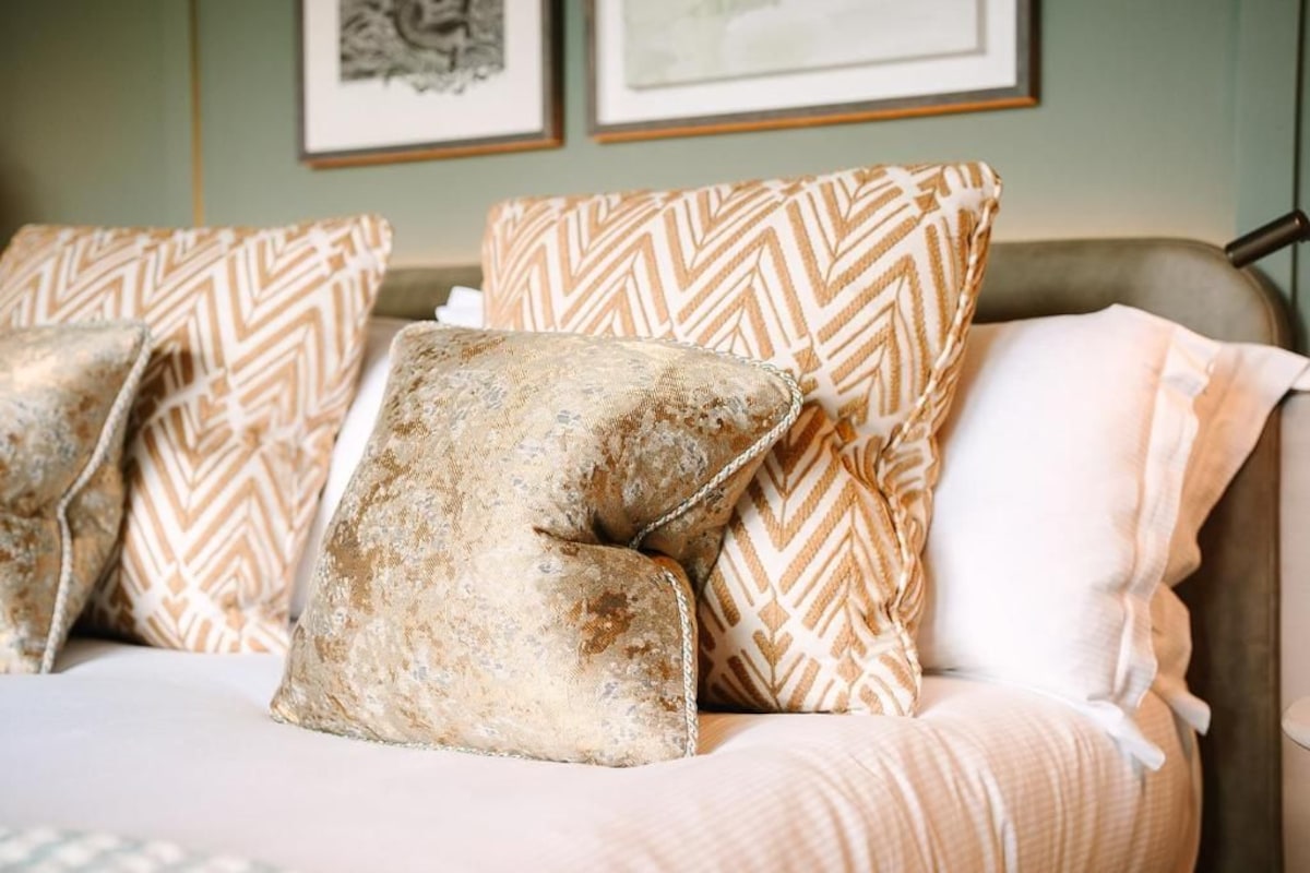 A sofa with patterned cushions and a blanket.