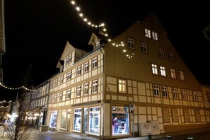 A traditional half-timbered building with multiple ground-floor shops and a second-floor residential area. - Mountain apart 2||Wernigerode (Wernigerode)