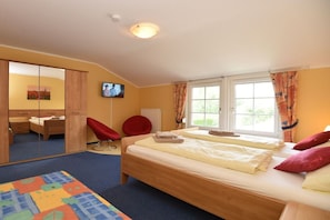 A bedroom with a bed, a chair, a desk, a television, and a window. - Holiday home with 3 bedrooms (Ilmtal \/ OT Traßdorf)