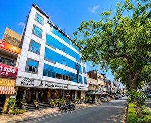 A multi-story building with a blue and white facade, a visible entrance with steps, and a sign for 'Pagoda Resorts Inn' on the ground floor. - Pagoda Resorts Inn (Sri Ganganagar)