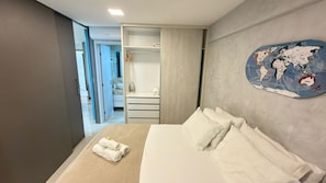 A hotel room with a bed, a wardrobe, and a world map on the wall. - New Listing (Natal)