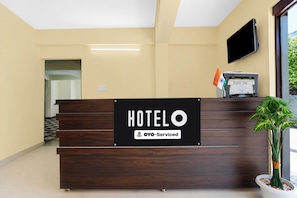 A hotel reception desk with a sign indicating it is 'HOTEL' and 'OYO-Serviced'. - Hotel O Kashi Ghat Varanasi (Varanasi)