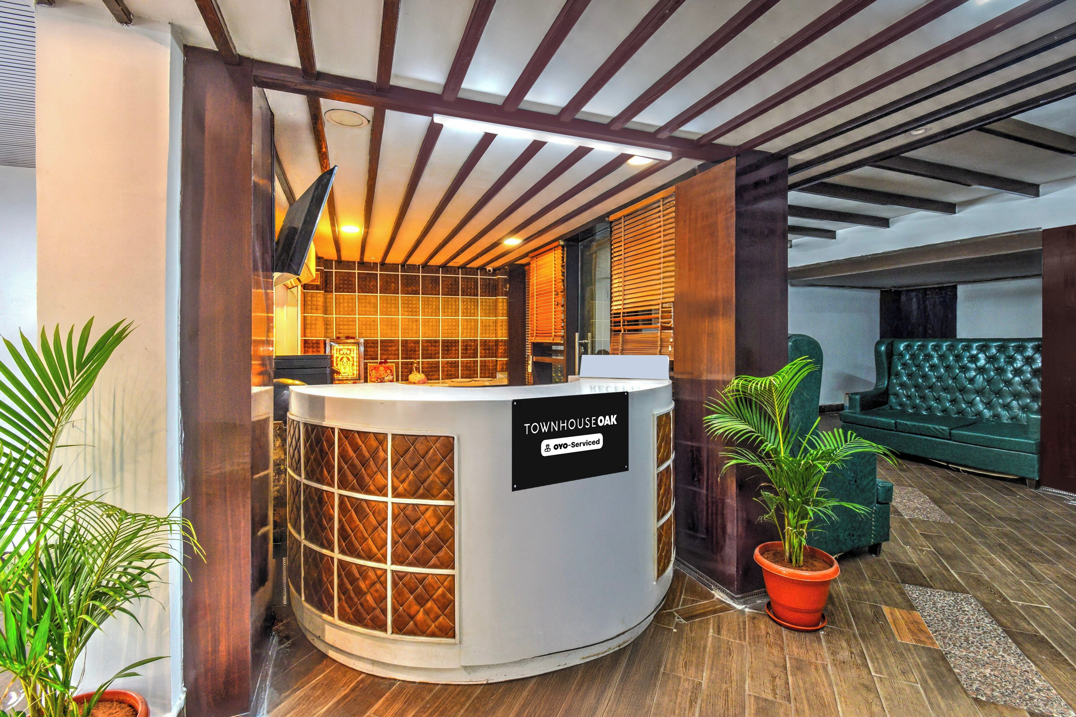 A reception area with a sign reading 'TOWNHOUSE OAK' and a sign indicating 'OYO-Serviced'.